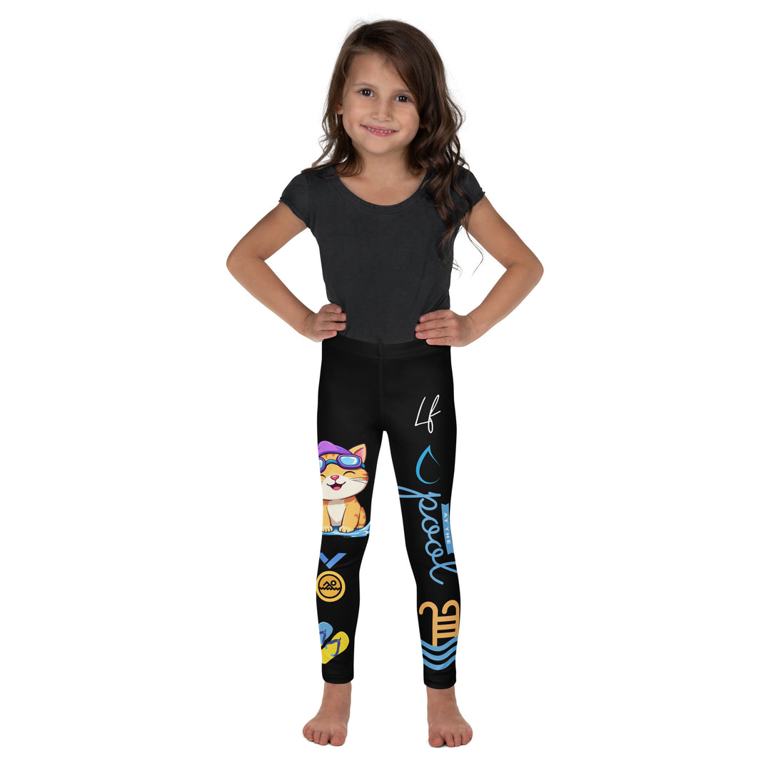 Aqua Kitty Winner Girls Leggings, black background with a blue and yellow swimmer cat wearing a diving mask and swim cap on one leg, golden medal and pool slippers below, "at the pool" text with water drop, and pool water with ladder on the other leg, front view on model
