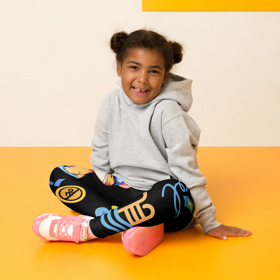 Aqua Kitty Winner Girls Leggings, black background with a blue and yellow swimmer cat wearing a diving mask and swim cap on one leg, golden medal and pool slippers below, "at the pool" text with water drop, and pool water with ladder on the other leg, seated pose on model