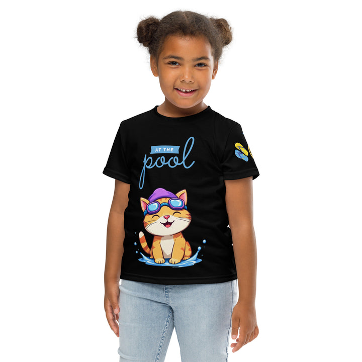 Aqua Kitty Winner Girls T-shirt, black background with a blue and yellow swimmer cat wearing diving goggles and a swim cap on the front, blue "At the pool" text above, water with drops below, golden medal and pool slippers on the left sleeve, and pool water waves with ladder on the back, front pose with arms at sides on model