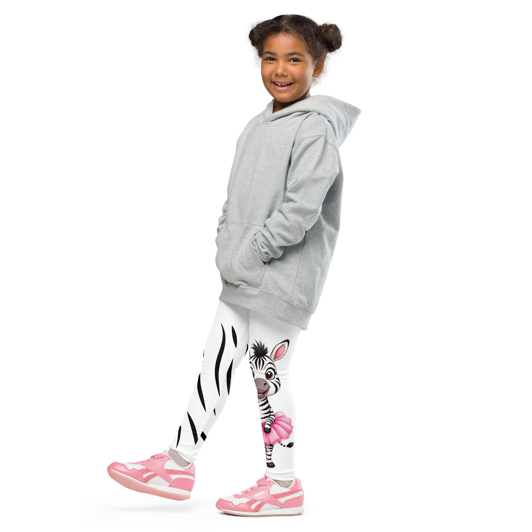 Ballet Black and White Zebra Girls Leggings, white background with a black and white zebra wearing a pink ballet skirt on the lower part of one leg, and black zebra stripes on the lower part of the other leg, side view with one leg lifted and extended on model