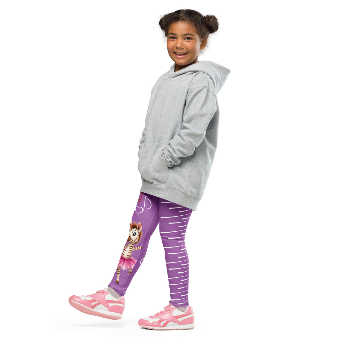 Ballet Sweet Zebra Girls Leggings, purple background with a brown and white zebra in a pink ballet skirt standing on one leg with arms extended, brown music notes above, and white vertical stripes running down the opposite leg, side view with one leg lifted and extended on model