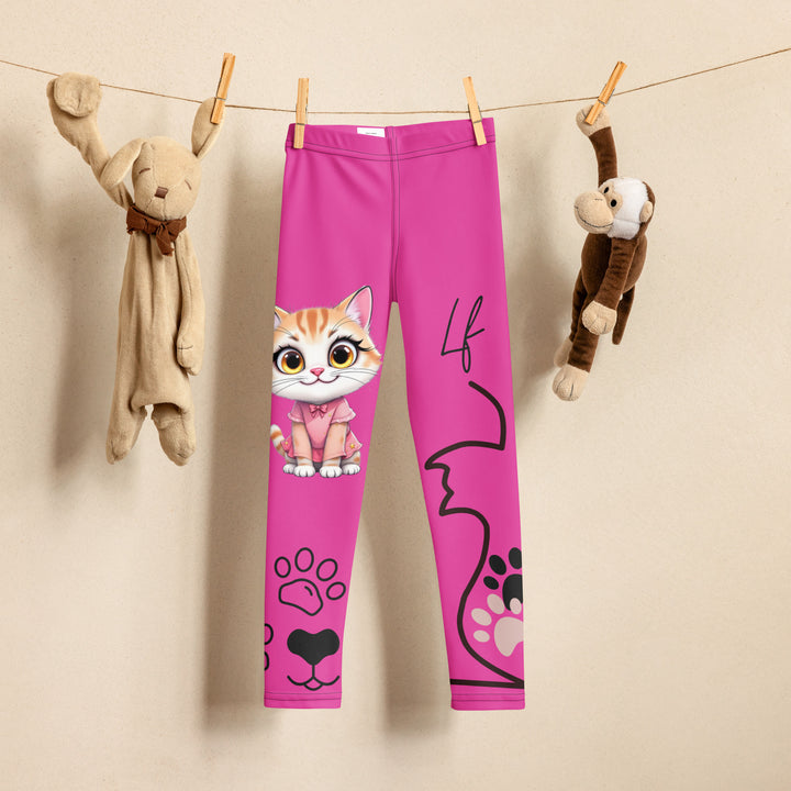 Cat Trace Girls Leggings, pink background with a yellow cat wearing a pink dress at the top of one leg, black paw prints and a black cat nose below, and a black line-drawn cat with black and cream paw prints on the other leg, front view on hanger
