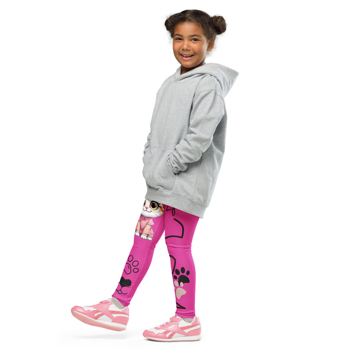 Cat Trace Girls Leggings, pink background with a yellow cat wearing a pink dress at the top of one leg, black paw prints and a black cat nose below, and a black line-drawn cat with black and cream paw prints on the other leg, side view with one leg lifted and extended on model