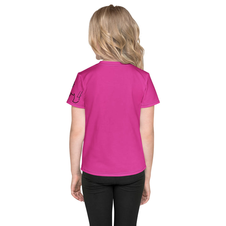  Cat Trace Girls T-shirt, pink background with a yellow cat sitting and wearing a light pink dress, with big eyes, long eyelashes, and a smiling expression on the front, and a black line-drawn cat with one black paw and one cream paw on the left sleeve, back view on model