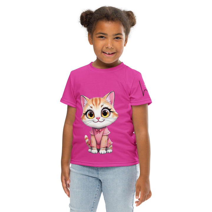 Cat Trace Girls T-shirt, pink background with a yellow cat sitting and wearing a light pink dress, with big eyes, long eyelashes, and a smiling expression on the front, and a black line-drawn cat with one black paw and one cream paw on the left sleeve, relaxed front pose on model