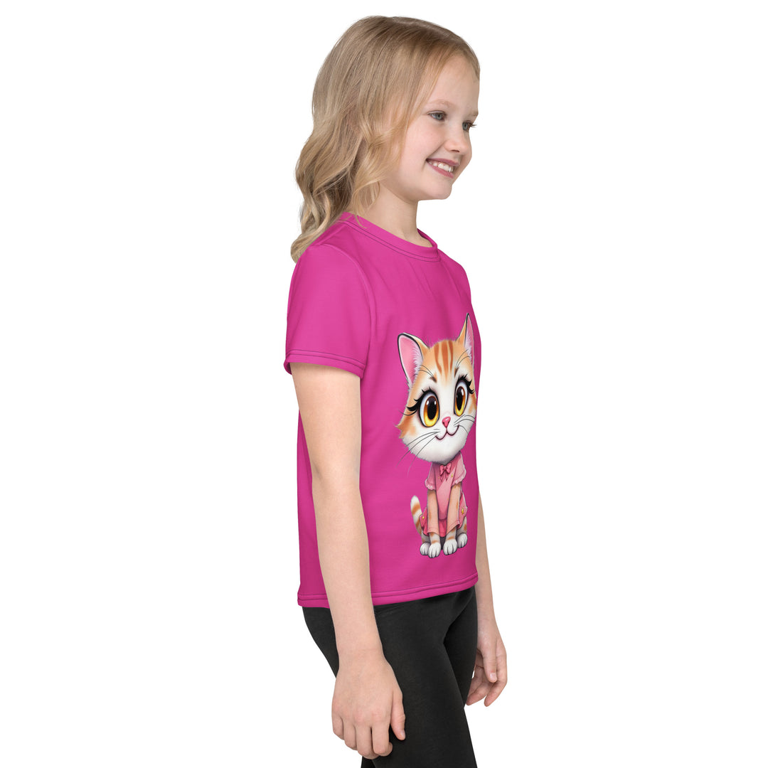 Cat Trace Girls T-shirt, pink background with a yellow cat sitting and wearing a light pink dress, with big eyes, long eyelashes, and a smiling expression on the front, and a black line-drawn cat with one black paw and one cream paw on the left sleeve, right side view on model