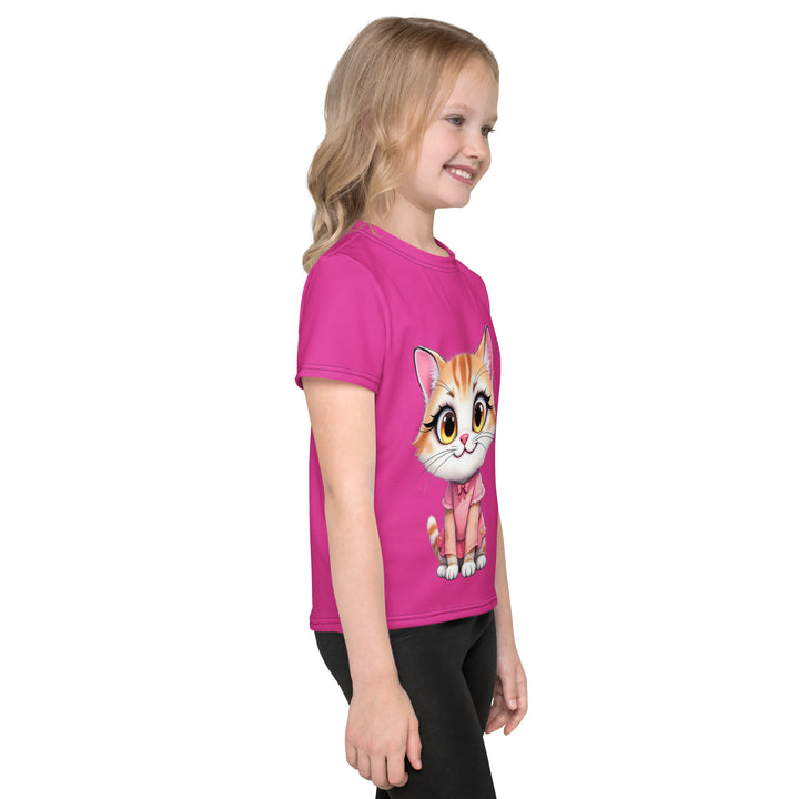 Cat Trace Girls T-shirt, pink background with a yellow cat sitting and wearing a light pink dress, with big eyes, long eyelashes, and a smiling expression on the front, and a black line-drawn cat with one black paw and one cream paw on the left sleeve, right side view on model
