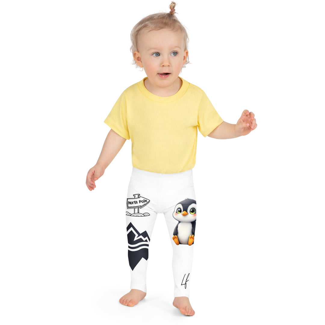  Chilly Penguin Girls Leggings, white background with a black and white small penguin sitting with green eyes on one leg, and a black and white iceberg with a wooden snow sign that says "NORTH POLE" on the other leg, front close-up view on model