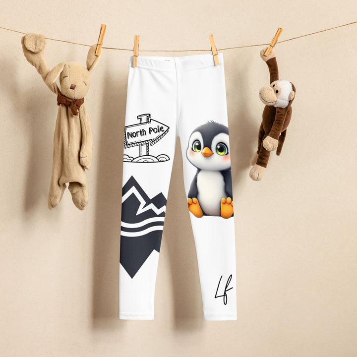 Chilly Penguin Girls Leggings, white background with a black and white small penguin sitting with green eyes on one leg, and a black and white iceberg with a wooden snow sign that says "NORTH POLE" on the other leg, front view on hanger