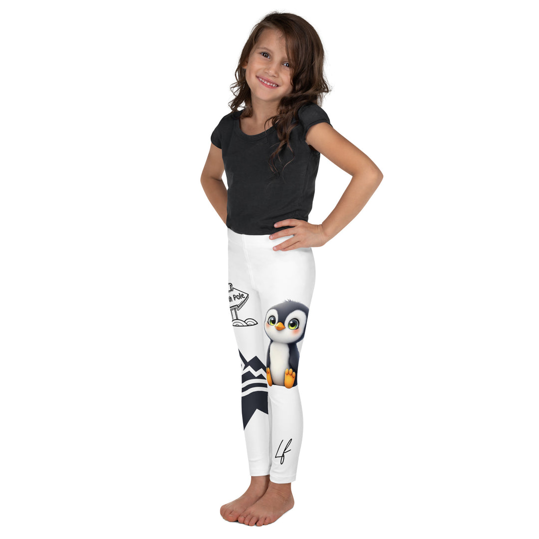 Chilly Penguin Girls Leggings, white background with a black and white small penguin sitting with green eyes on one leg, and a black and white iceberg with a wooden snow sign that says "NORTH POLE" on the other leg, left side view on model