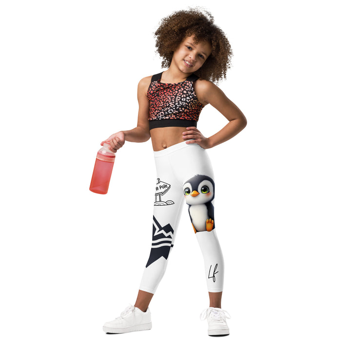 Chilly Penguin Girls Leggings, white background with a black and white small penguin sitting with green eyes on one leg, and a black and white iceberg with a wooden snow sign that says "NORTH POLE" on the other leg, relaxed front pose on model