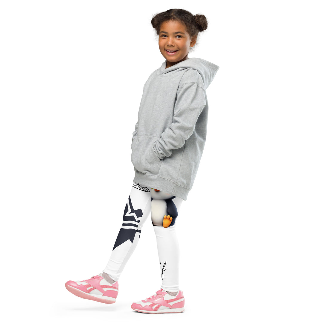 Chilly Penguin Girls Leggings, white background with a black and white small penguin sitting with green eyes on one leg, and a black and white iceberg with a wooden snow sign that says "NORTH POLE" on the other leg, side view with one leg lifted and extended on model