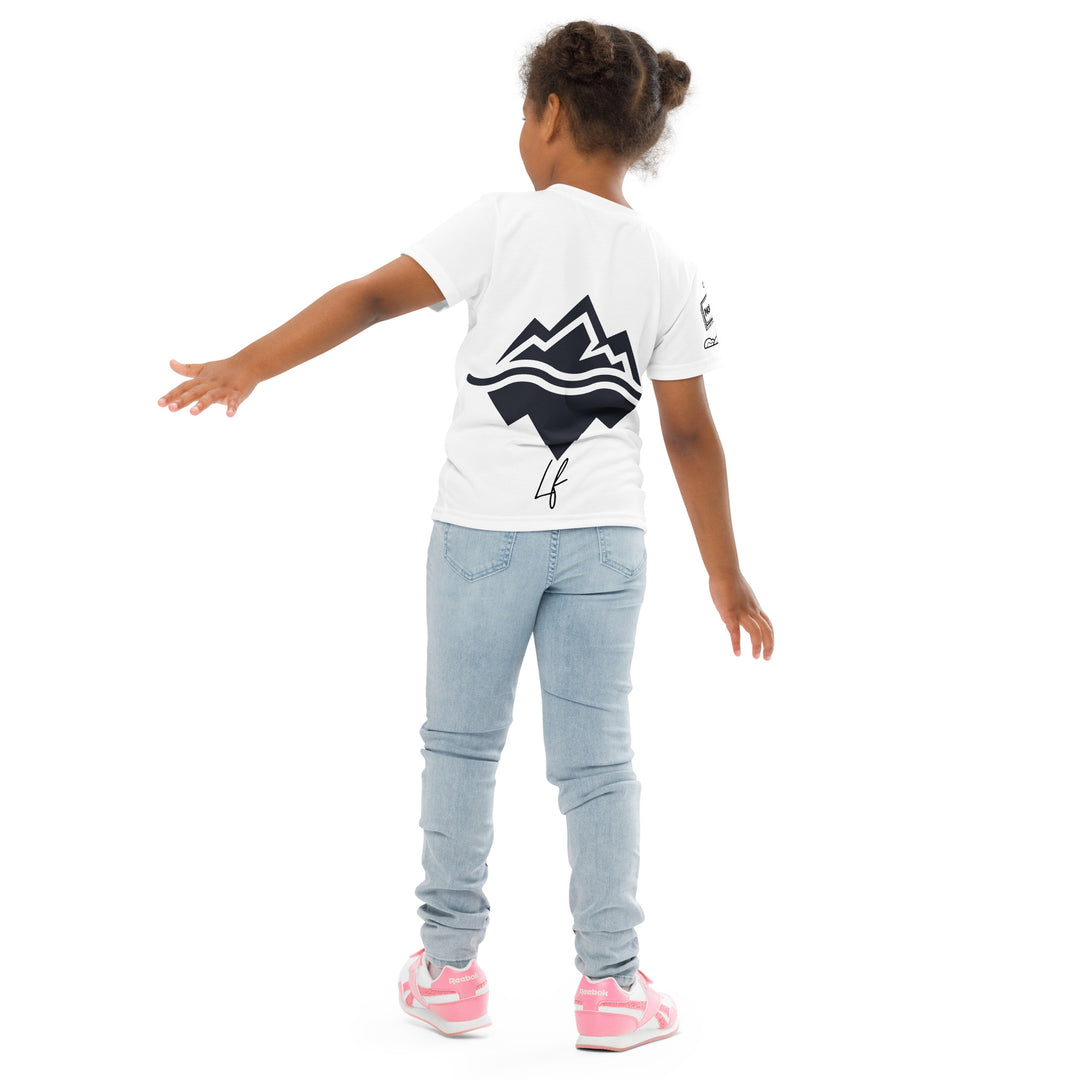 Chilly Penguin Girls T-shirt, white background with a black and white baby penguin sitting with green eyes on the front, a black line snow sign with "NORTH POLE" text on the left sleeve, and a black and white iceberg on the back, back pose on model