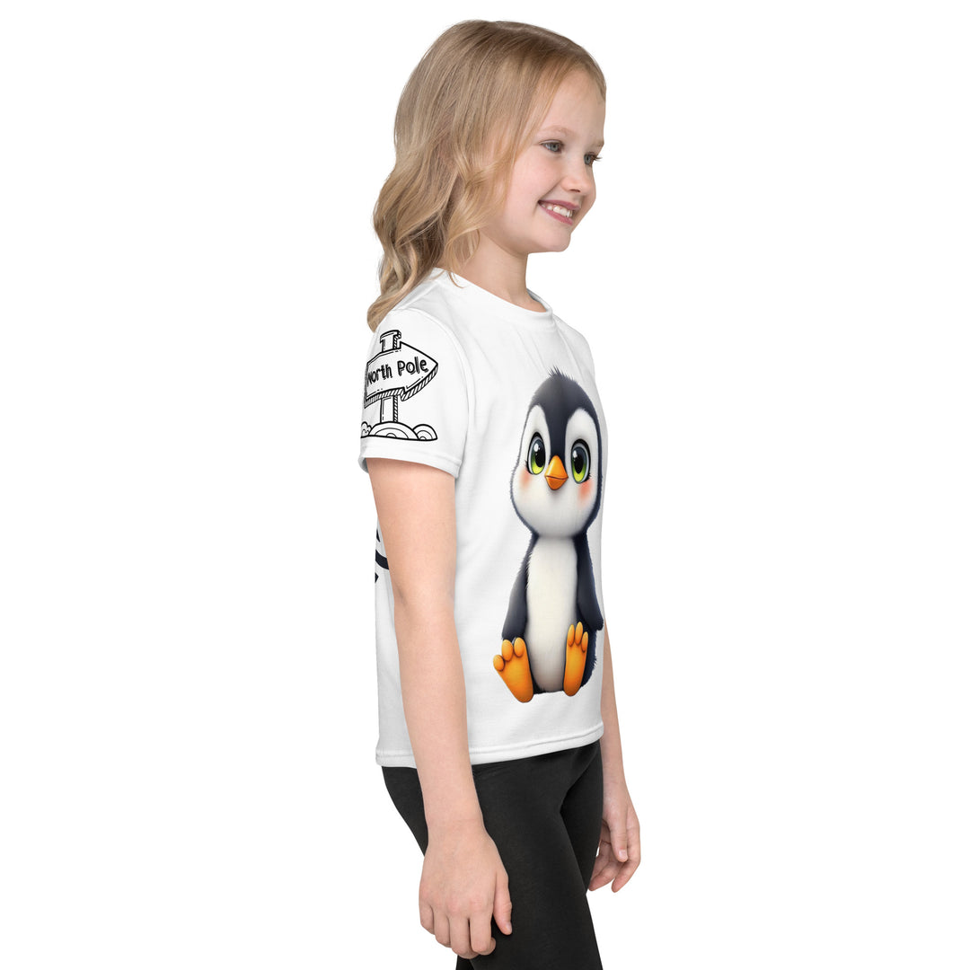 Chilly Penguin Girls T-shirt, white background with a black and white baby penguin sitting with green eyes on the front, a black line snow sign with "NORTH POLE" text on the left sleeve, and a black and white iceberg on the back, right side view on model