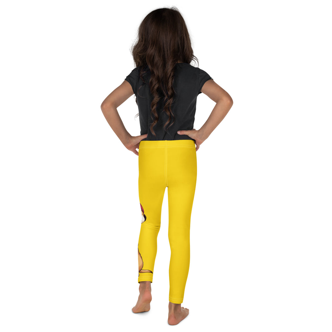 Cool Meerkat Girls Leggings, yellow background with a meerkat wearing a red cap on one leg and a paw graphic on the other leg appearing to come through the fabric, back view on model