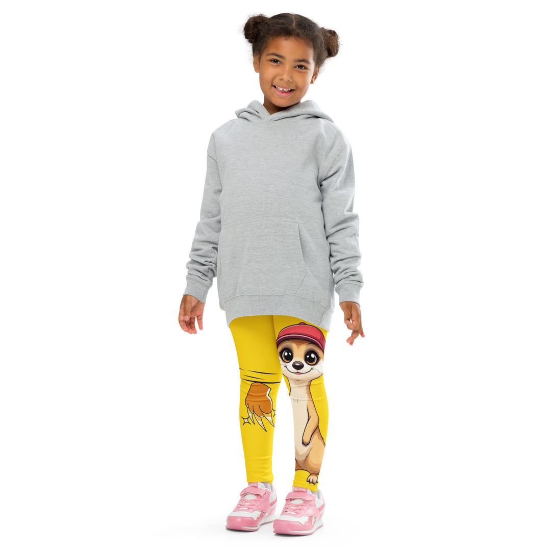  Cool Meerkat Girls Leggings, yellow background with a meerkat wearing a red cap on one leg and a paw graphic on the other leg appearing to come through the fabric, front pose with arms at sides on model
