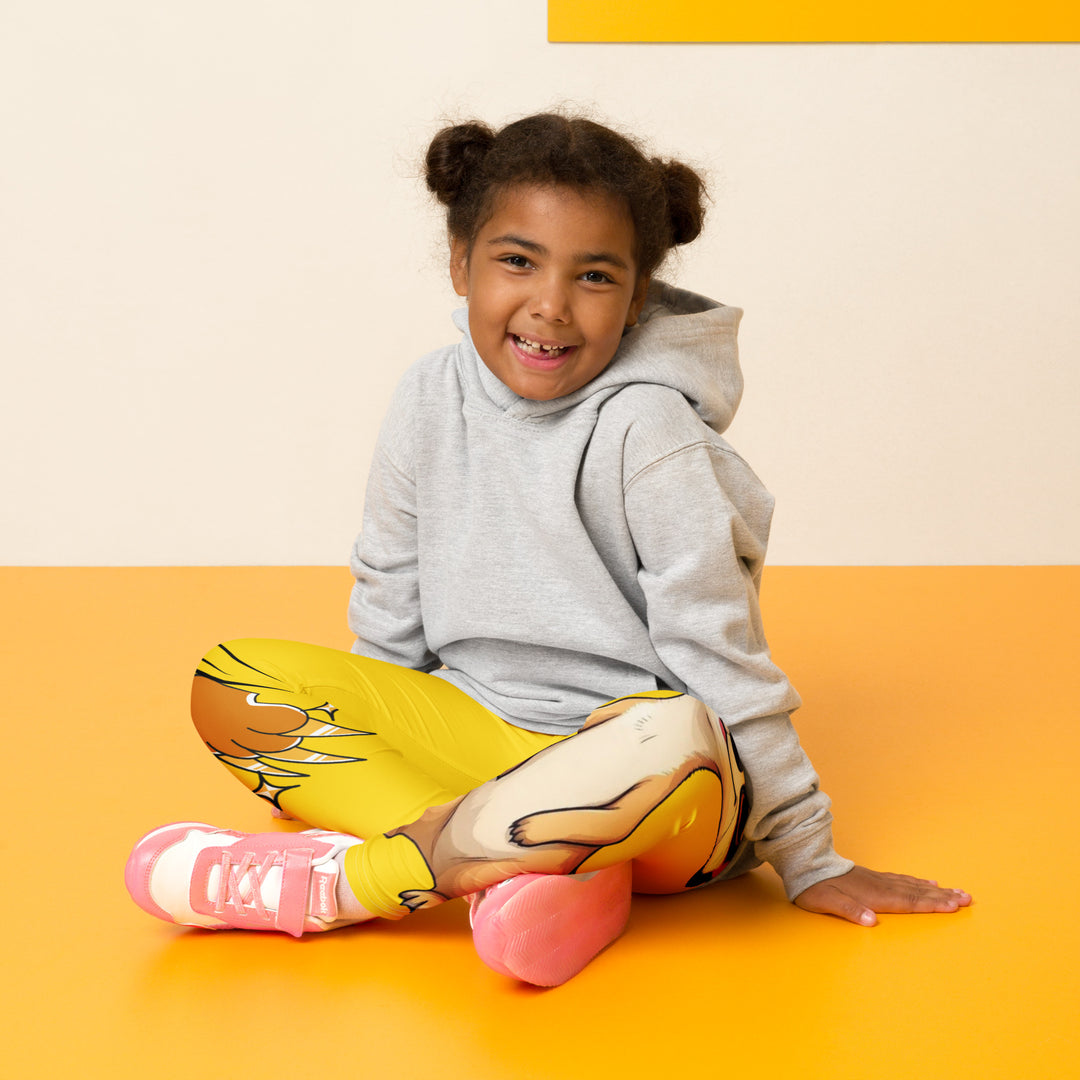  Cool Meerkat Girls Leggings, yellow background with a meerkat wearing a red cap on one leg and a paw graphic on the other leg appearing to come through the fabric, seated pose on model