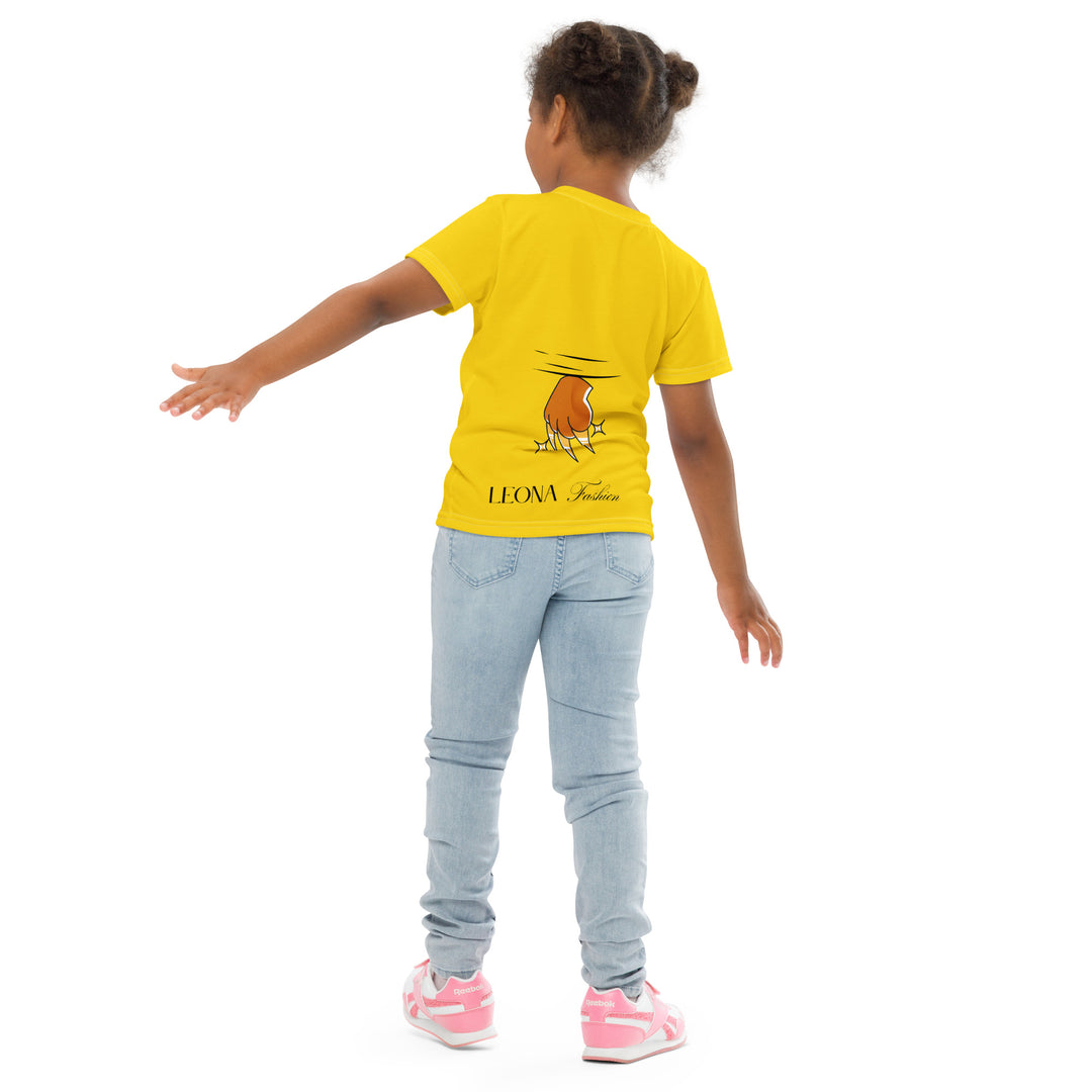 Cool Meerkat Girls T-shirt, yellow background with a meerkat wearing a red cap on the front, and a paw graphic on the back appearing to come through the fabric, back angle with relaxed pose on model-with a visible 'Leona Fashion' text on the design
