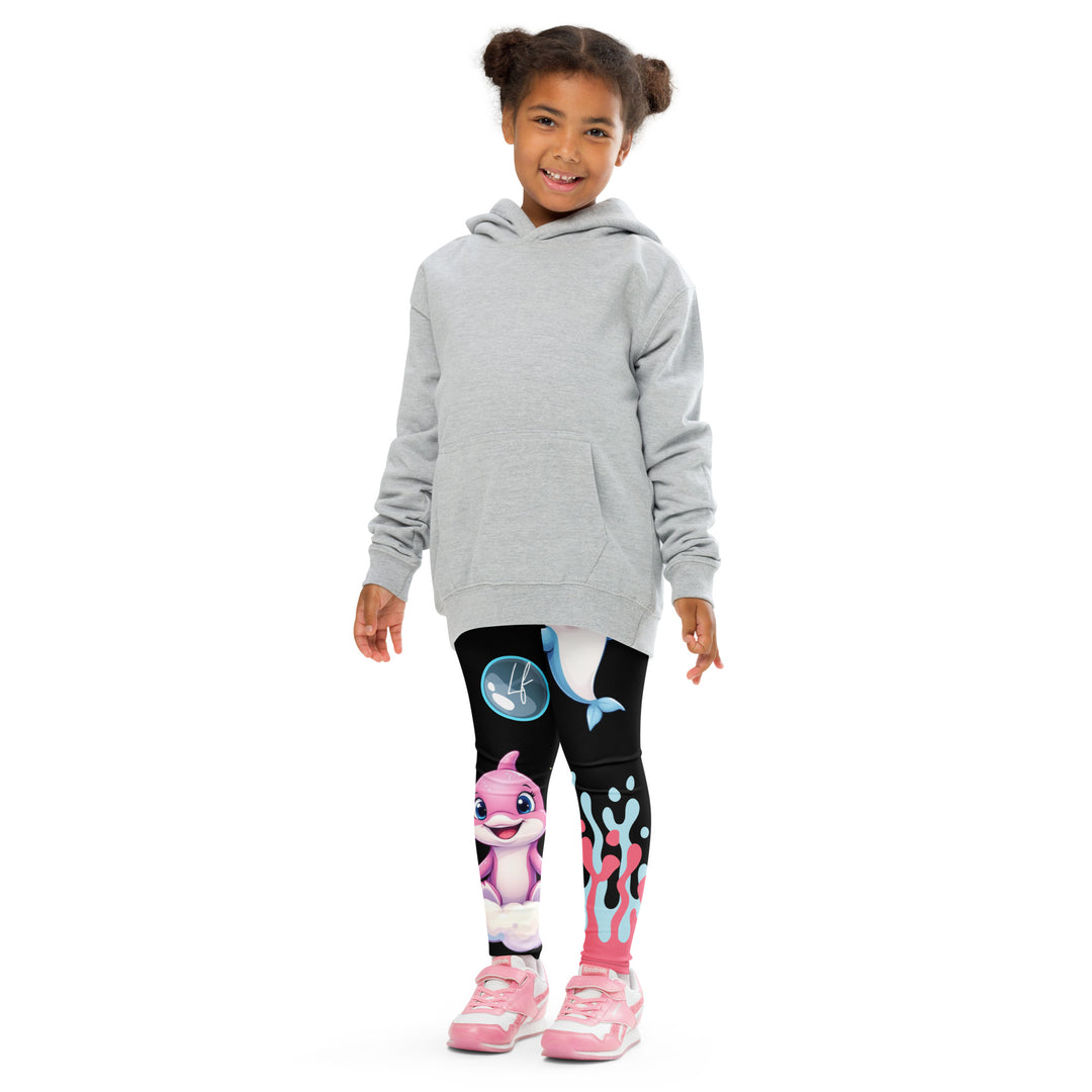  Coral Dolphin Girls Leggings, black background with a pink baby dolphin lying on a white cloud at the bottom of one leg and blue sea bubbles above, and a blue baby dolphin on the upper part of the other leg with pink and blue coral details at the bottom, front pose with arms at sides on model