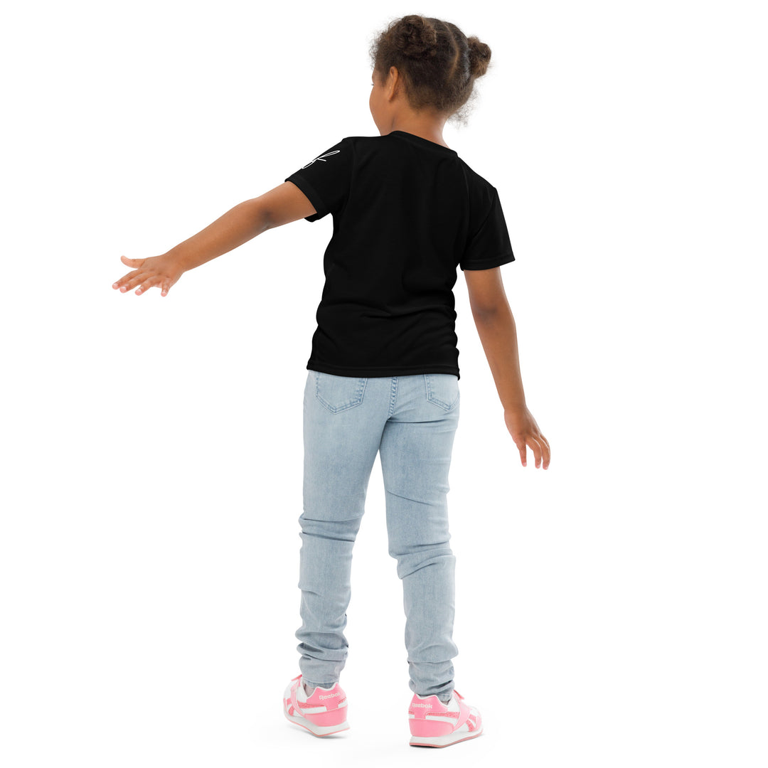 Coral Dolphin Girls T-shirt, black background with a pink baby dolphin sitting on a white cloud surrounded by small sparkling yellow stars, back pose on model
