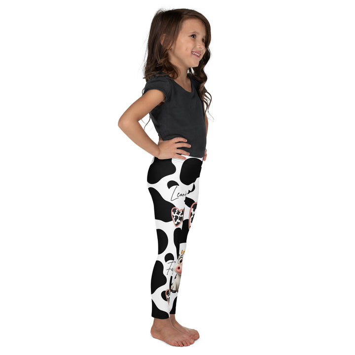 Cowlicious Love Girls Leggings, white background with black cow-like spots and a small black and white cow with a flower in its hair on one leg, right side view on model-with a visible 'Leona Fashion' text on the design