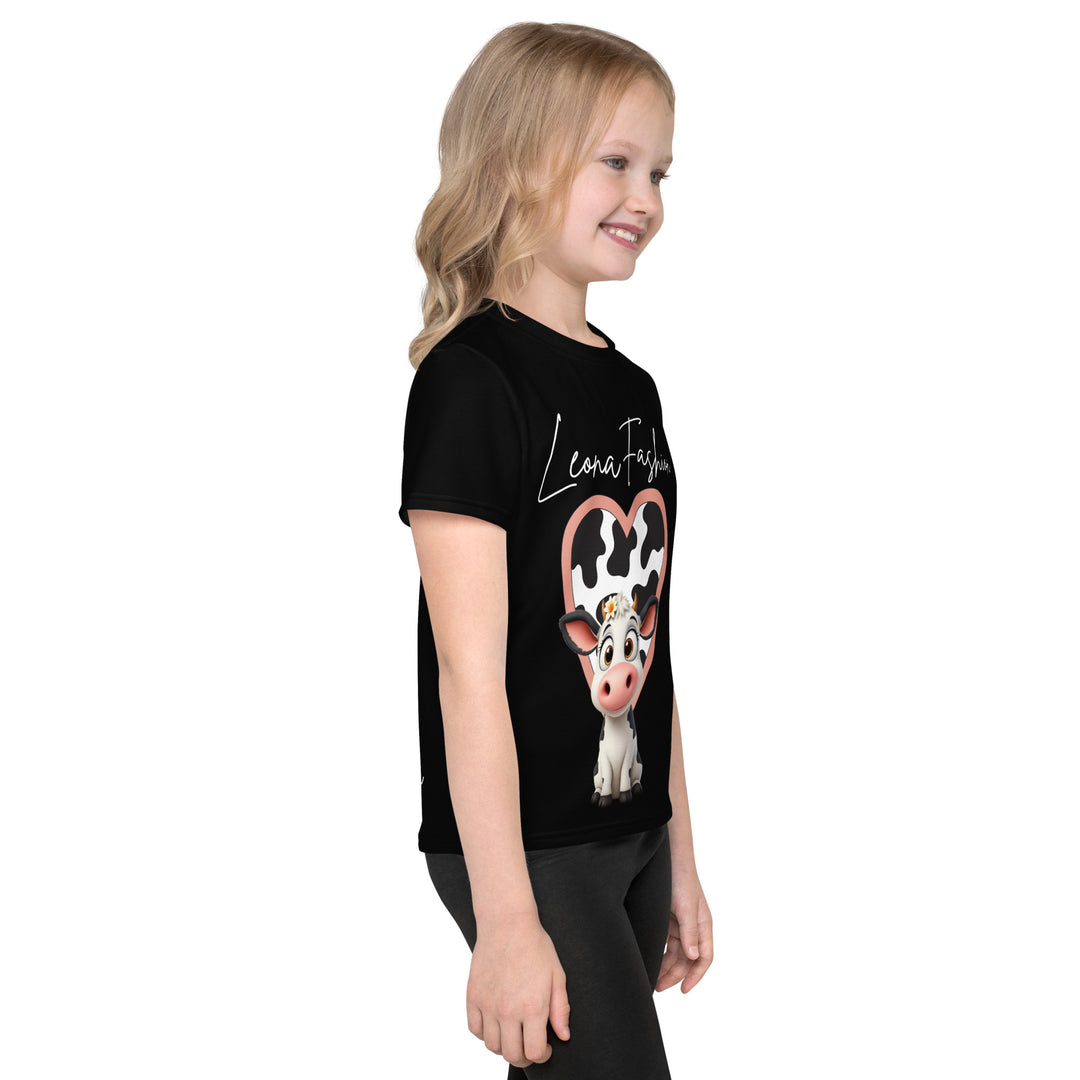 Cowlicious Love Girls T-shirt, black background with a black and white cow featuring a flower in its hair on the front, and a black and white cow-print heart outlined in pink behind it, right side view on model-with a visible 'Leona Fashion' text on the design