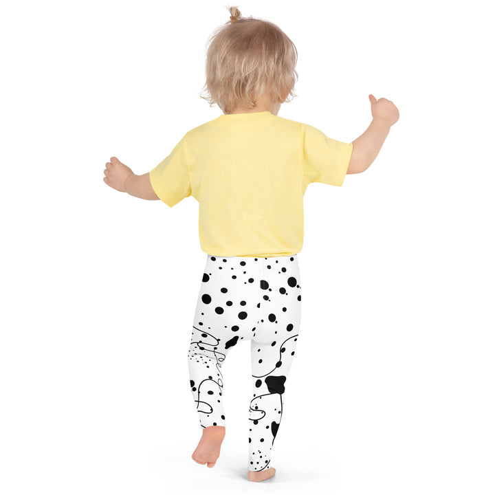 Dot & Line Girls Leggings, white background with black spots, lines, and dots interwoven throughout the design, back pose on model