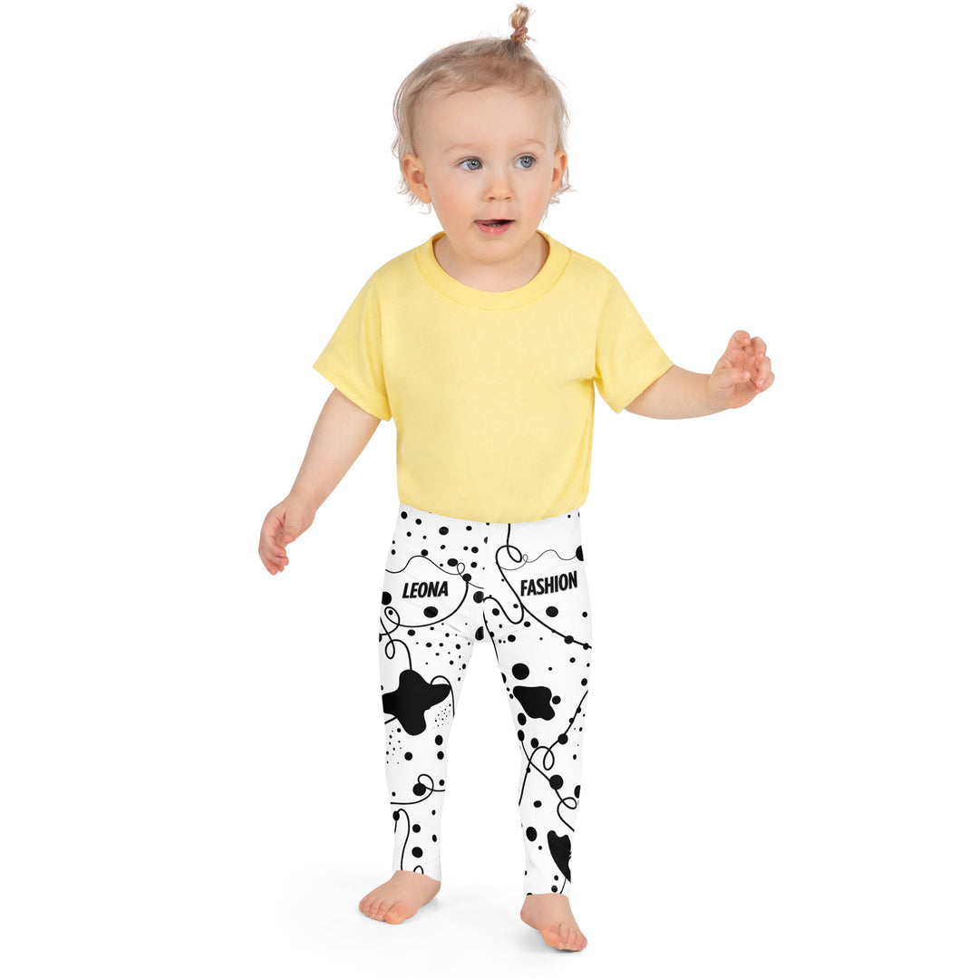Dot & Line Girls Leggings, white background with black spots, lines, and dots interwoven throughout the design, front close-up view on model-with a visible 'Leona Fashion' text on the design