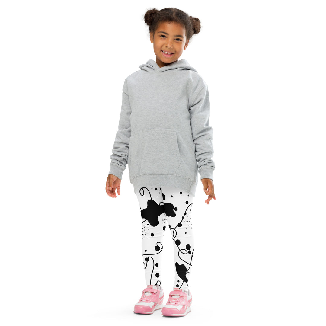 Dot & Line Girls Leggings, white background with black spots, lines, and dots interwoven throughout the design, front pose with arms at sides on model-with a visible 'Leona Fashion' text on the design