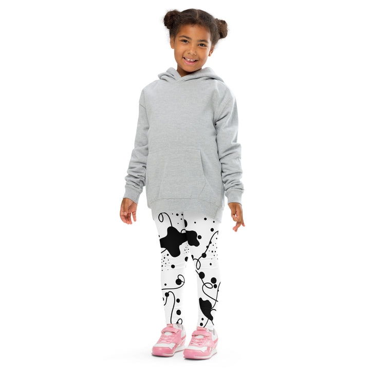  Dot & Line Girls Leggings, white background with black spots, lines, and dots interwoven throughout the design, front pose with arms at sides on model-with a visible 'Leona Fashion' text on the design