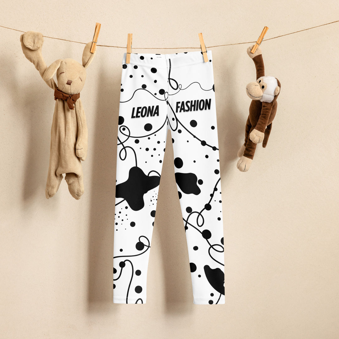 Dot & Line Girls Leggings, white background with black spots, lines, and dots interwoven throughout the design, front view on hanger-with a visible 'Leona Fashion' text on the design