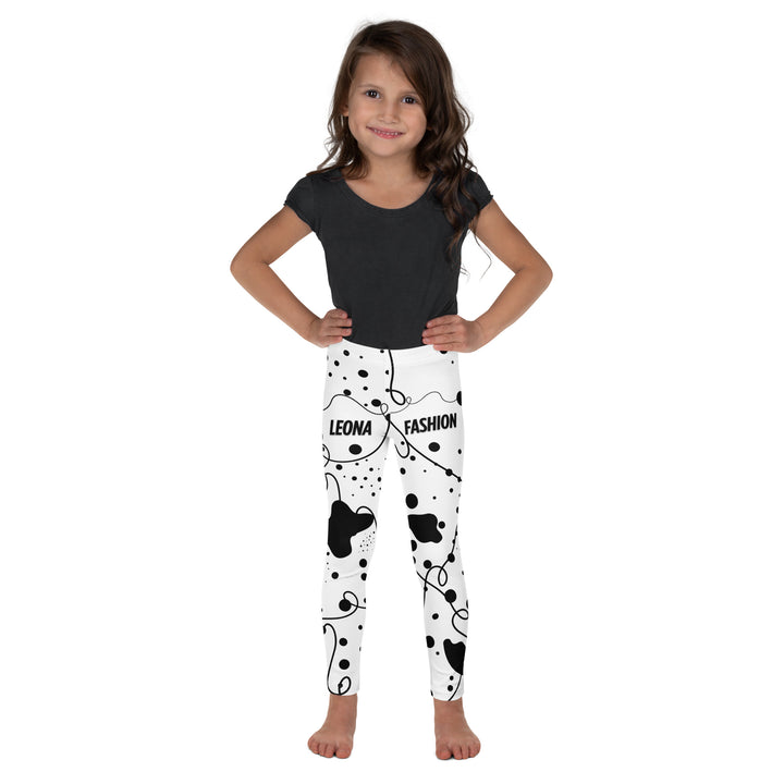 Dot & Line Girls Leggings, white background with black spots, lines, and dots interwoven throughout the design, front view on model-with a visible 'Leona Fashion' text on the design