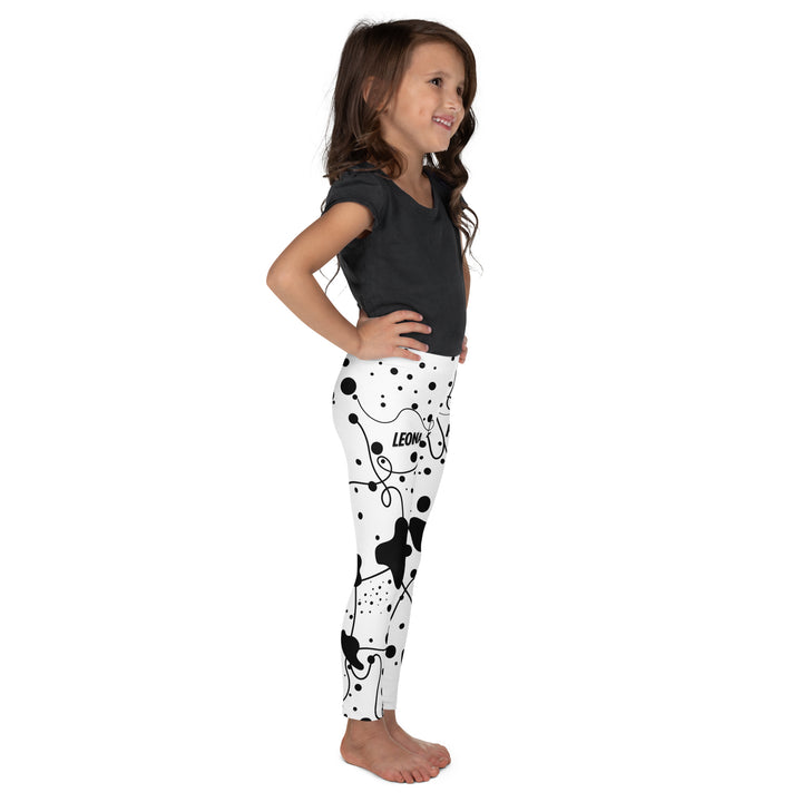Dot & Line Girls Leggings, white background with black spots, lines, and dots interwoven throughout the design, right side view on model