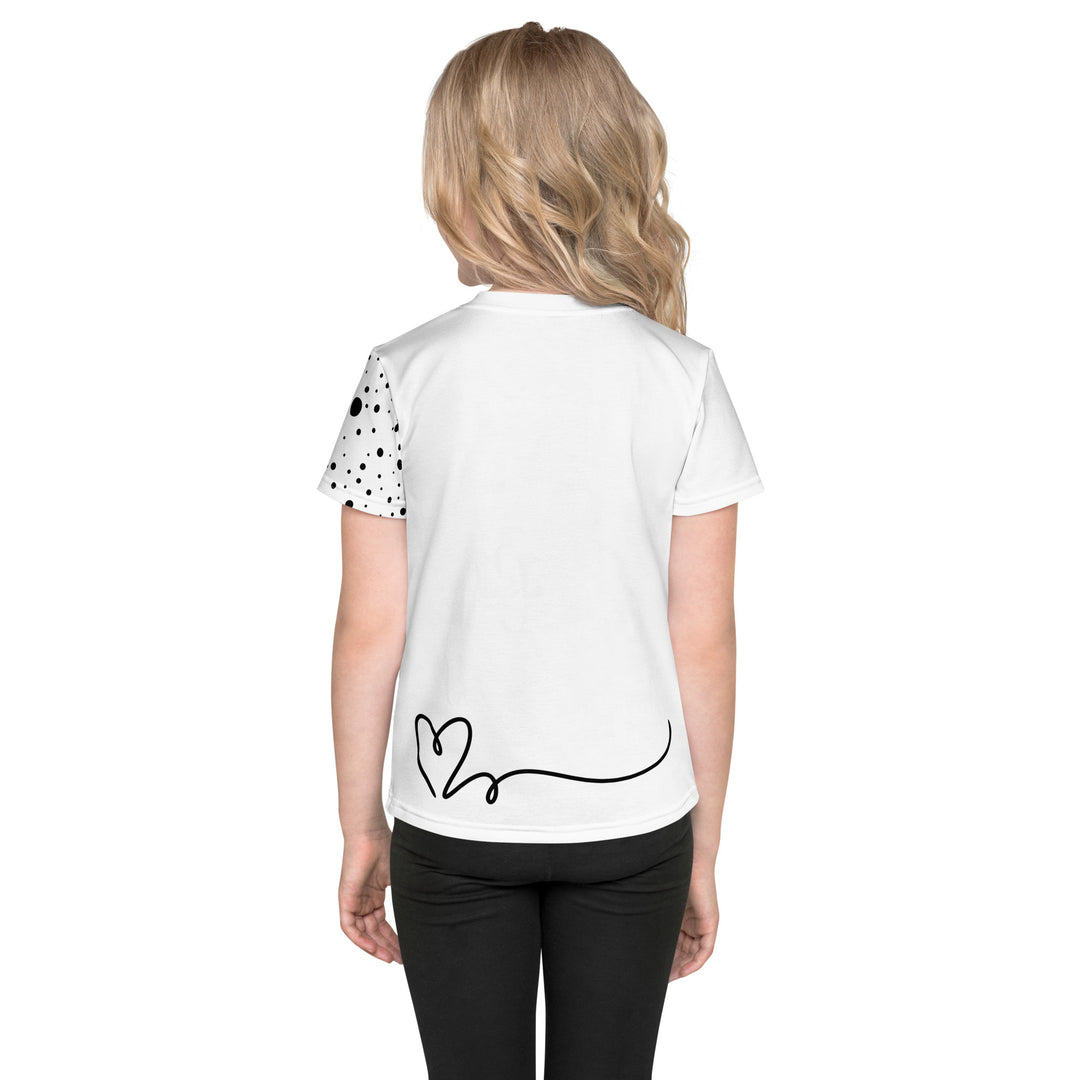 Dot & Line Girls T-shirt, white background with black spots, lines, and a heart on the front, black dots on the left sleeve, and a black heart with a line detail near the bottom on the back, back view on model