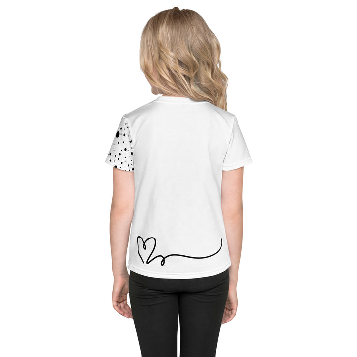 Dot & Line Girls T-shirt, white background with black spots, lines, and a heart on the front, black dots on the left sleeve, and a black heart with a line detail near the bottom on the back, back view on model