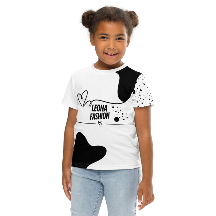 Dot & Line Girls T-shirt, white background with black spots, lines, and a heart on the front, black dots on the left sleeve, and a black heart with a line detail near the bottom on the back, front pose with arms at sides on model-with a visible 'Leona Fashion' text on the design