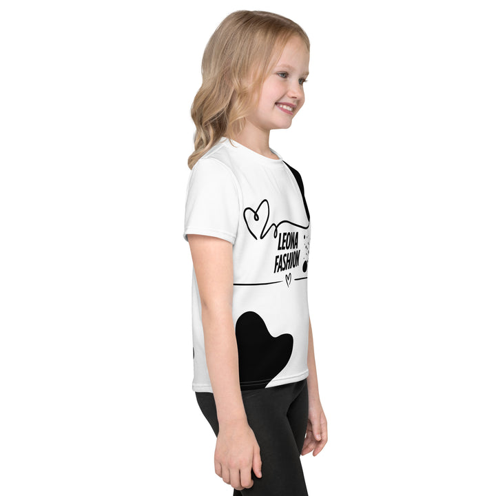 Dot & Line Girls T-shirt, white background with black spots, lines, and a heart on the front, black dots on the left sleeve, and a black heart with a line detail near the bottom on the back, right side view on model-with a visible 'Leona Fashion' text on the design