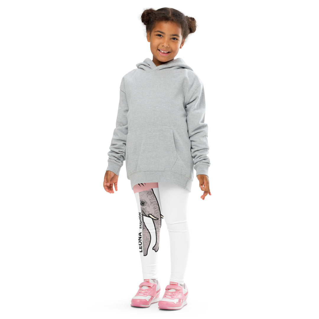 Elephant Whispers Girls Leggings, white background with gray elephant in profile on one leg, visible trunk, and soft blush pink stripe detail across the head, front pose with arms extended on model-with a visible 'Leona Fashion' text on the design