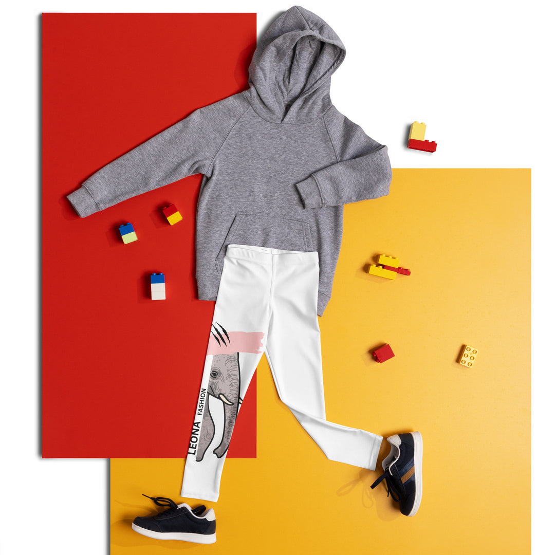 Elephant Whispers Girls Leggings, white background with gray elephant in profile on one leg, visible trunk, and soft blush pink stripe detail across the head, front view laid flat on floor-with a visible 'Leona Fashion' text on the design
