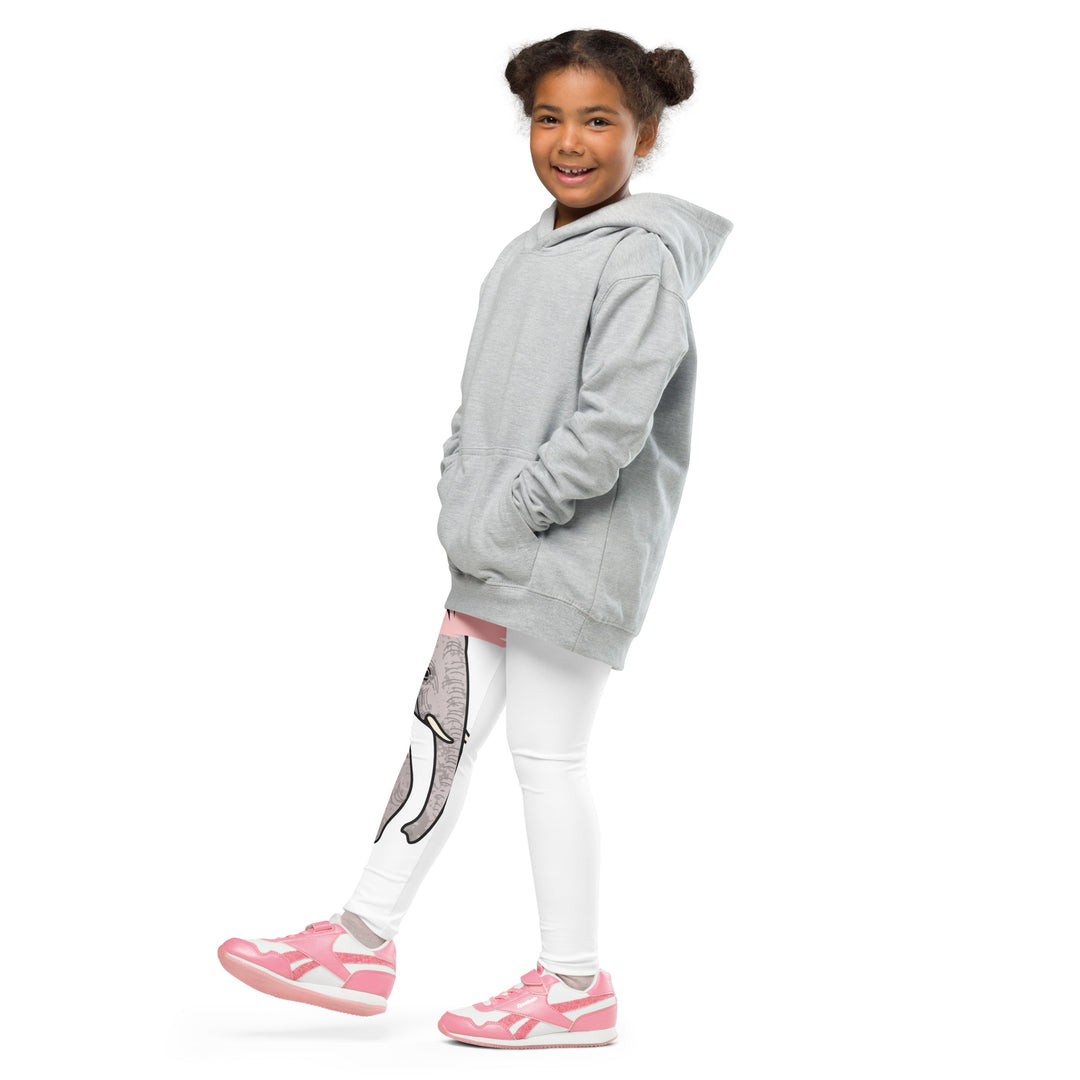 Elephant Whispers Girls Leggings, white background with gray elephant in profile on one leg, visible trunk, and soft blush pink stripe detail across the head, front view with one leg lifted and extended on model