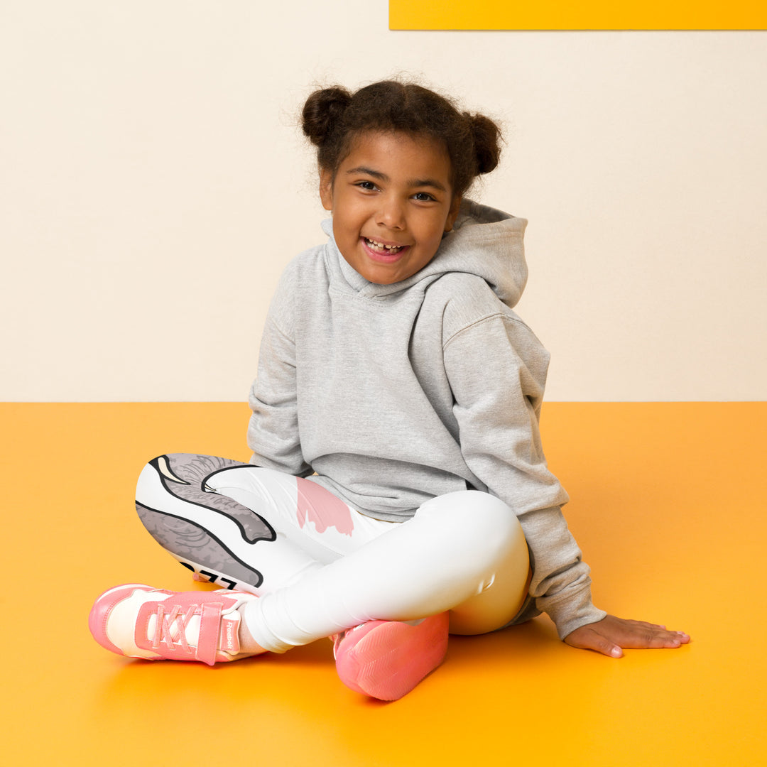  Elephant Whispers Girls Leggings, white background with gray elephant in profile on one leg, visible trunk, and soft blush pink stripe detail across the head, seated pose on model