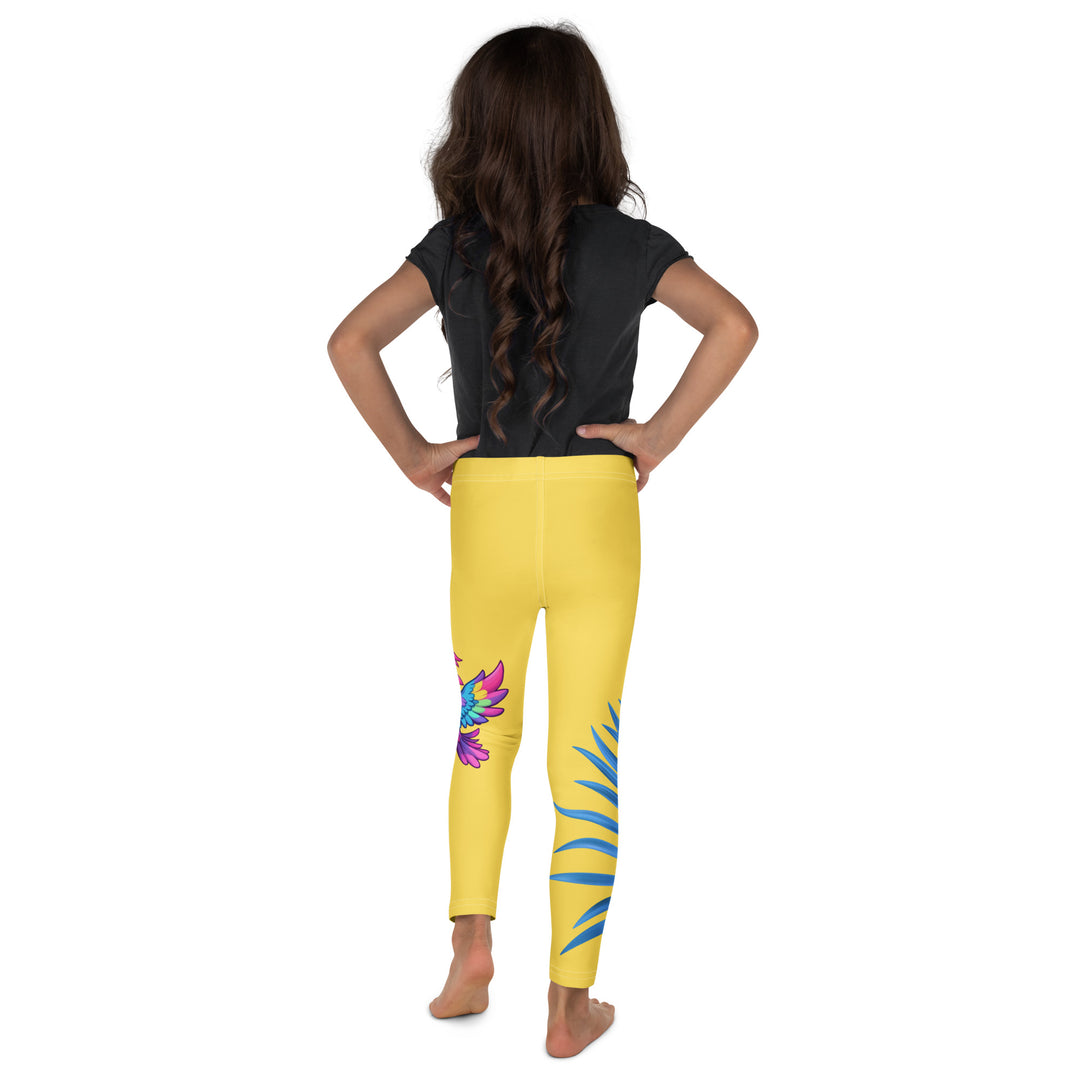 Fly Baby Parrot Girls Leggings, yellow background with a small pink baby parrot with spread wings on one leg, and a large blue tropical leaf with "I CAN DO IT" text in blue and pink letters above it on the other leg, back view on model