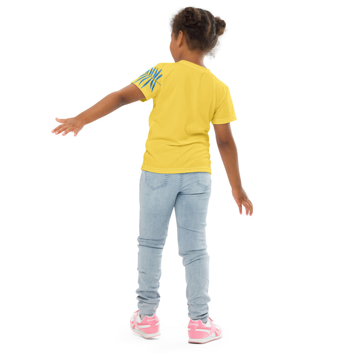  Fly Baby Parrot Girls T-shirt, yellow background with a small pink baby parrot with spread wings on the front, "I CAN DO IT" text in blue and pink letters below, and a blue tropical leaf on the left sleeve, back angle with relaxed pose on model