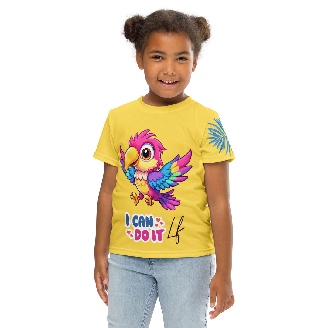 Fly Baby Parrot Girls T-shirt, yellow background with a small pink baby parrot with spread wings on the front, "I CAN DO IT" text in blue and pink letters below, and a blue tropical leaf on the left sleeve, front pose with arms at sides on model