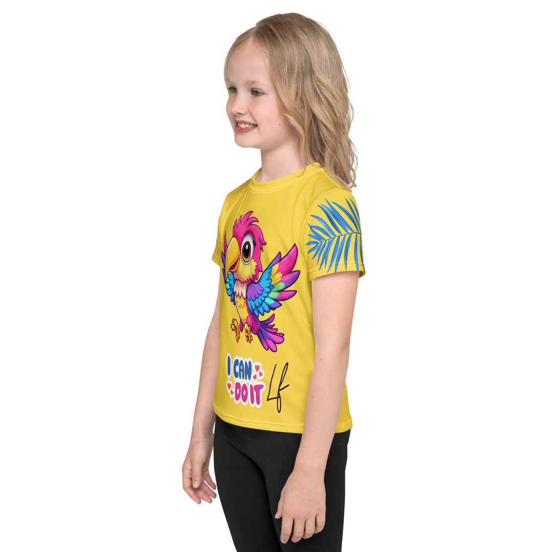 Fly Baby Parrot Girls T-shirt, yellow background with a small pink baby parrot with spread wings on the front, "I CAN DO IT" text in blue and pink letters below, and a blue tropical leaf on the left sleeve, left side view on model