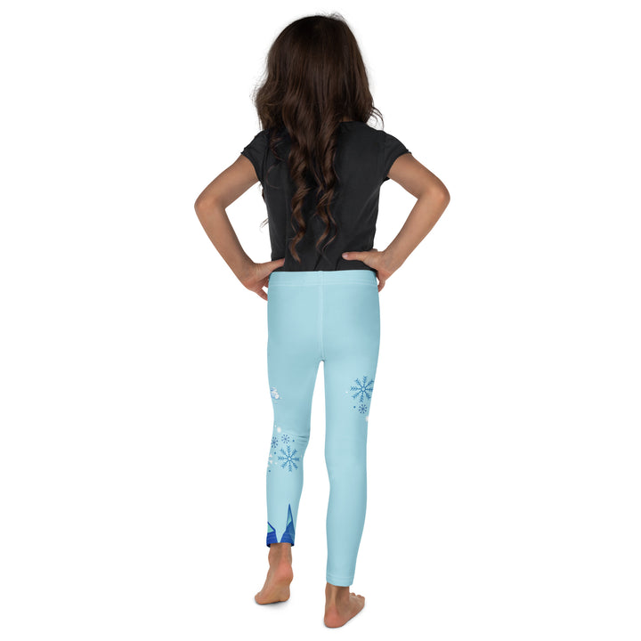 Frosty Seal Girls Leggings, light sky blue background with a white baby seal, blue and white snowflakes, and an ice block on one leg, and blue and white ice cubes with snowflakes on the other leg, back view on model