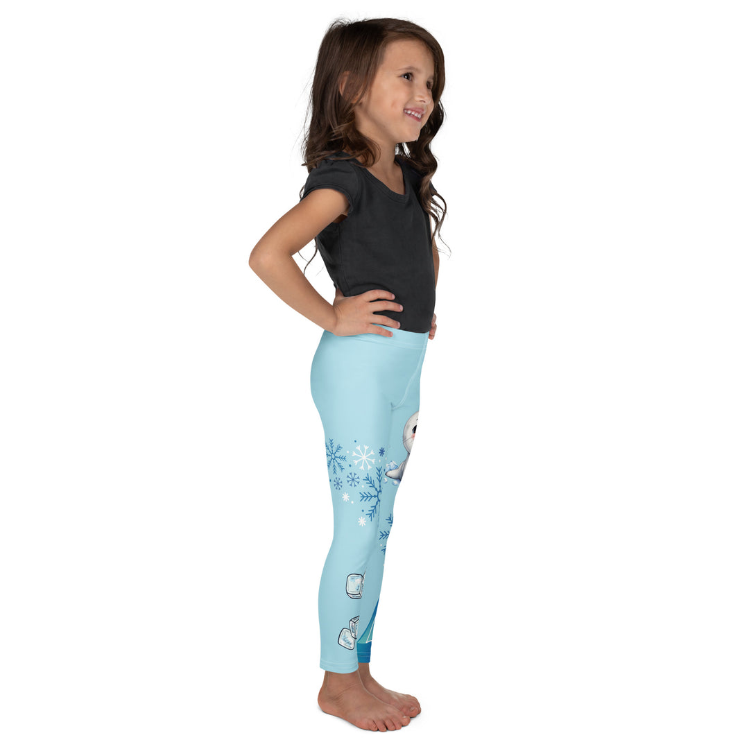  Frosty Seal Girls Leggings, light sky blue background with a white baby seal, blue and white snowflakes, and an ice block on one leg, and blue and white ice cubes with snowflakes on the other leg, right side view on model