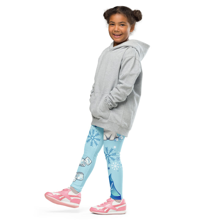  Frosty Seal Girls Leggings, light sky blue background with a white baby seal, blue and white snowflakes, and an ice block on one leg, and blue and white ice cubes with snowflakes on the other leg, side view with one leg lifted and extended on model