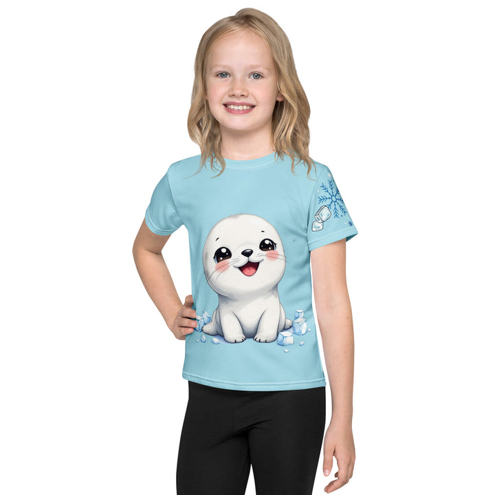 Frosty Seal Girls T-shirt, light sky blue background with a white baby seal surrounded by ice cubes on the front, blue and white snowflakes on the left sleeve, and an icy blue iceberg on the back, front view on model