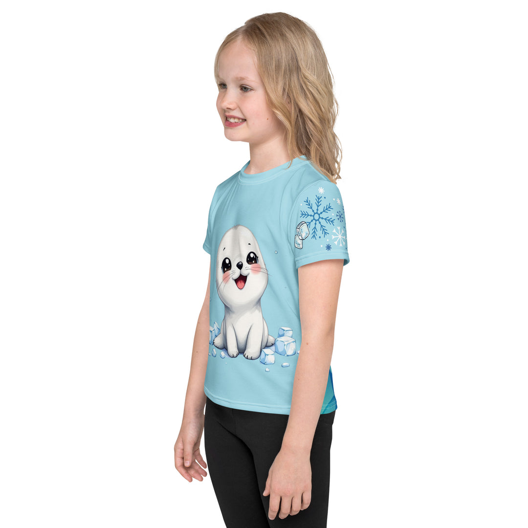 Frosty Seal Girls T-shirt, light sky blue background with a white baby seal surrounded by ice cubes on the front, blue and white snowflakes on the left sleeve, and an icy blue iceberg on the back, left side view on model